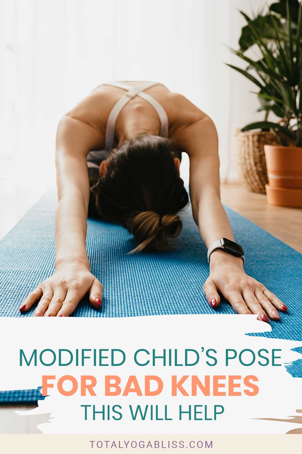 Woman doing yoga pose on a blue mat - Modified Child’s Pose For Bad Knees