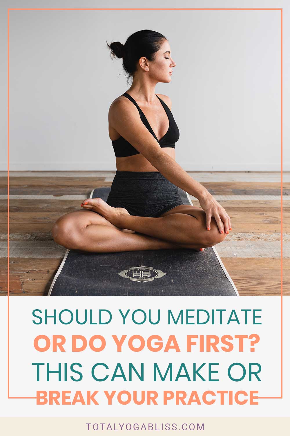 Woman doing yoga on a black yoga mat - Should You Meditate Or Do Yoga First?